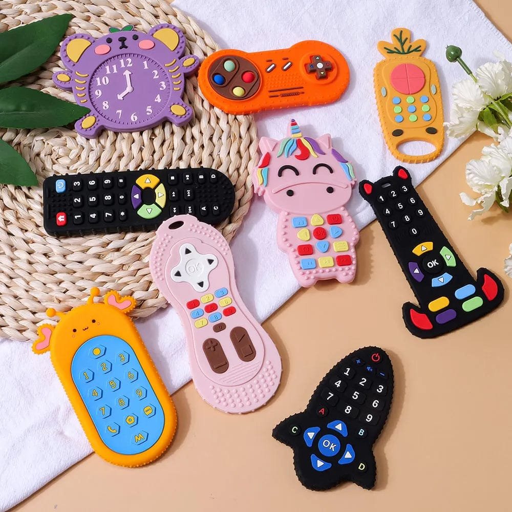 Silicone remote control baby teether toys in a styled flat lay for teething relief, baby gifting, and nursery play.