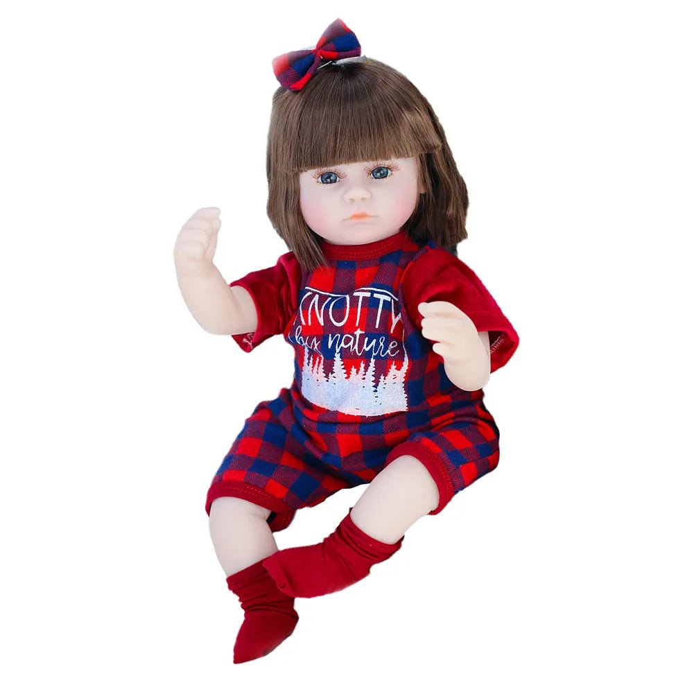 Doll wearing a red outfit with plaid accents and a blue bow on a white background
