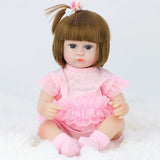 Toy doll with brown hair and a pink outfit.