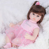 Doll in a pink outfit with a bow.