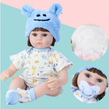 Baby doll with blue bear hat and pacifier.