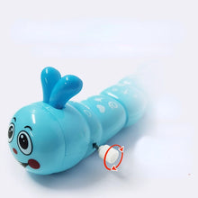 Close-up of a blue smiling wind-up caterpillar toy with an arrow showing how to turn the white key
