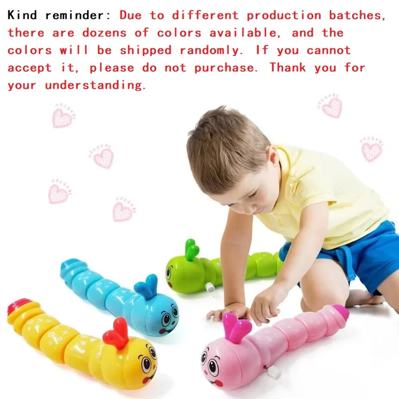 Boy playing with blue, green, yellow and pink wind-up caterpillar toys beside a note that colors ship randomly