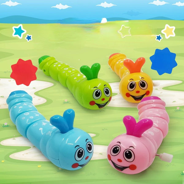 Blue, green, yellow and pink smiling wind-up caterpillar toys on a green grass track illustration