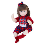 Doll wearing a red outfit with plaid accents and a bow on a white background