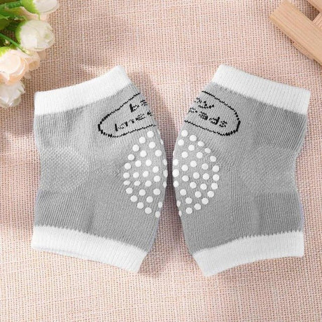 Pair of gray knee pads with white polka dots.