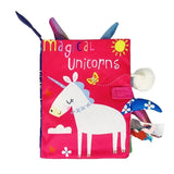 Children's soft book with unicorn illustration and 'magical unicorns' text on a pink cover.