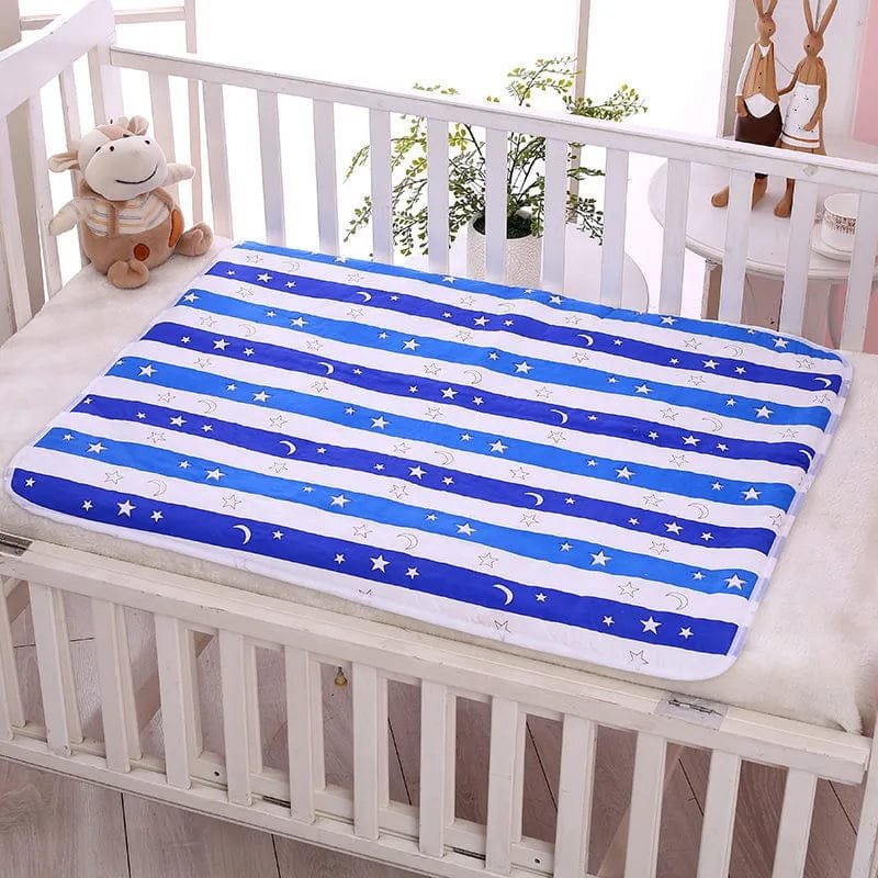 Blue and white striped blanket with star and moon pattern on a crib