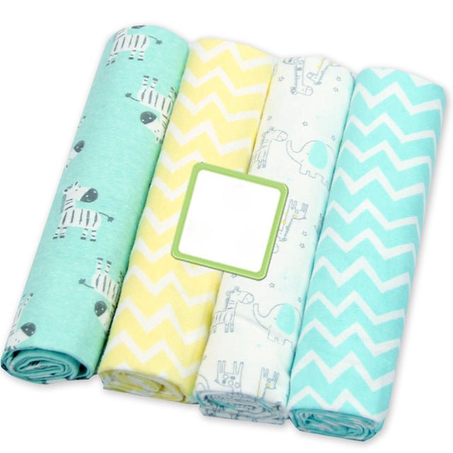 Soft cosy muslin newborn blankets displayed rolled in four prints, lightweight wraps for travel bags and pram shade.