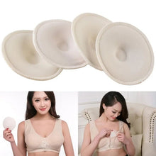 Soft cotton nursing pads worn with beige bras by two women in a living room, absorbent pads for nursing moms.