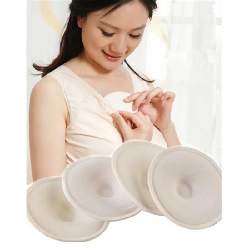 Woman holding a soft cotton nursing pad with extra pads displayed, an absorbent set for nursing moms on the go.