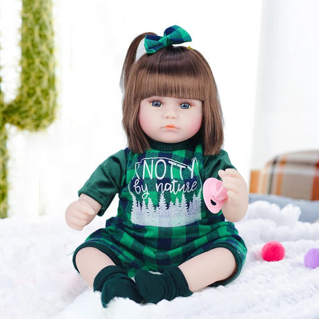  A doll in a green outfit with text sitting 
