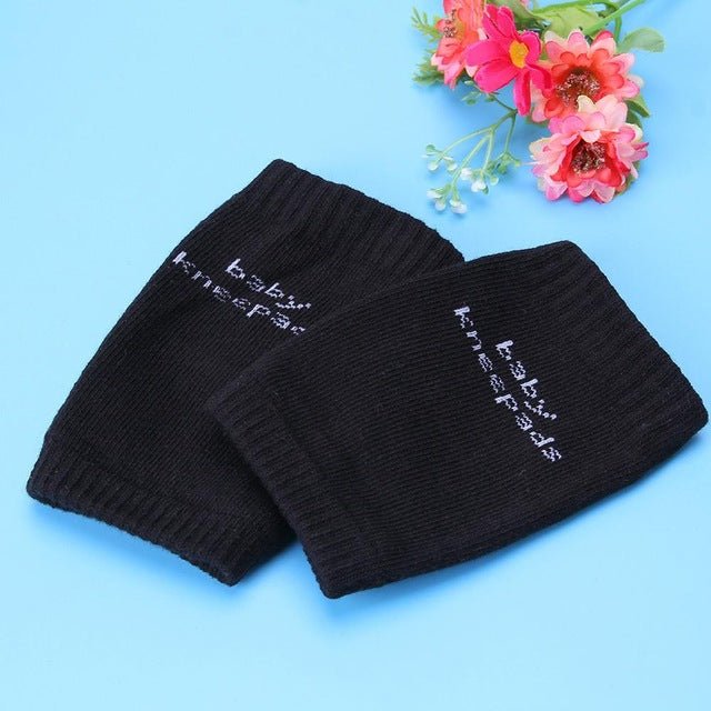 Two black baby knee pads with 'baby knee pads' text.