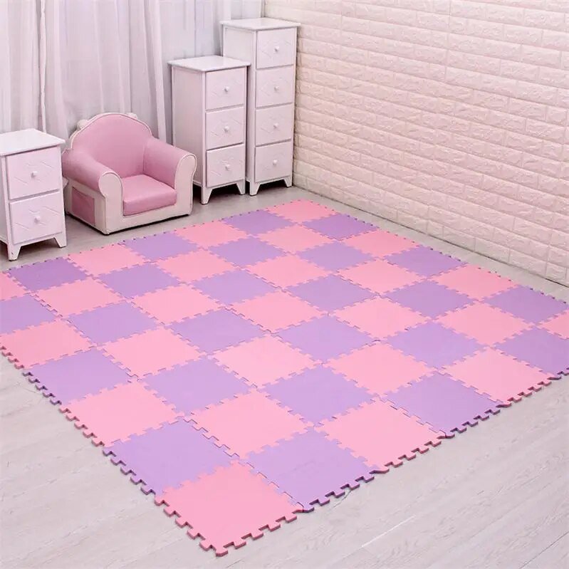 Checkered pink and purple mat on a light wooden floor with a pink chair and white drawers in the background.