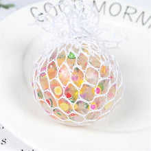 Soft grape fruit slice squishy ball packaged in a mesh gift bag for stress relief and party favor gifting.