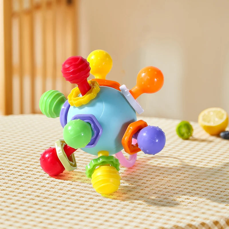 Blue grasping ball with colorful knobs on a woven tablecloth