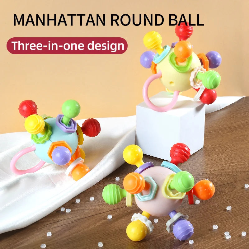 Three colorful grasping balls with textured knobs in blue, cream-yellow and lilac on a table