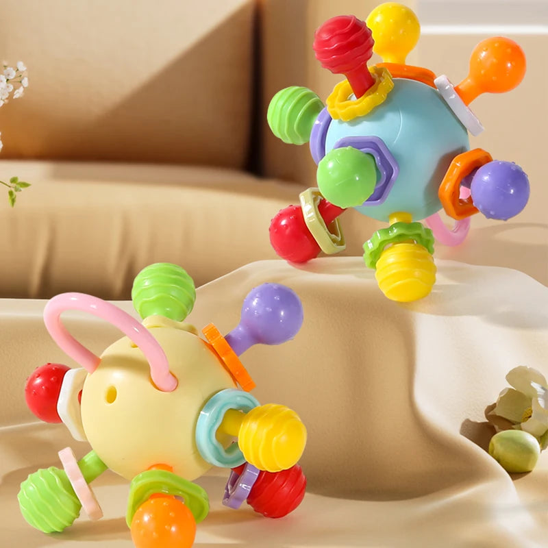 Yellow and blue grasping balls with colorful knobs on a sofa