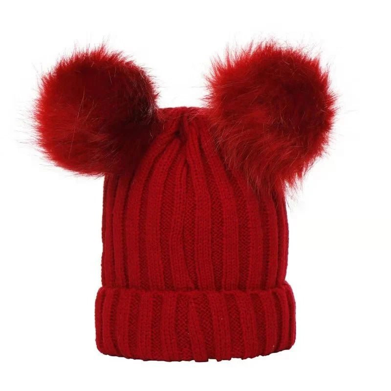 Red knit hat with two large red pom-poms