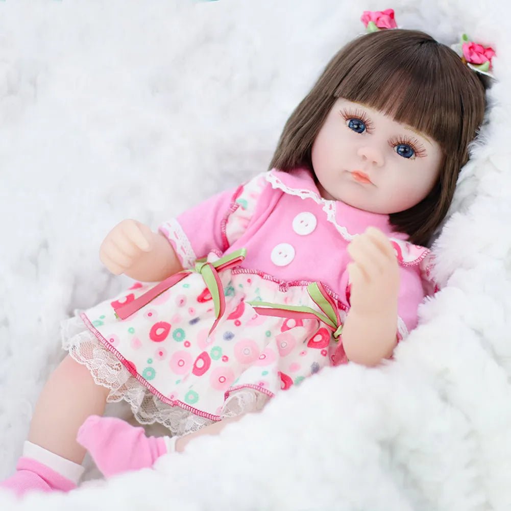 Doll in a pink outfit with a white background