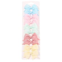 Soft pastel bowknot clips packaged for daily girls hair styling and birthday gifting.