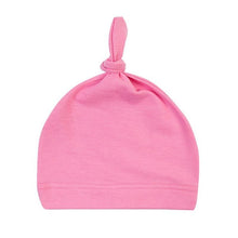 Soft pink baby knot hat in cotton as a newborn sleep cap for cosy naps and gentle head coverage.