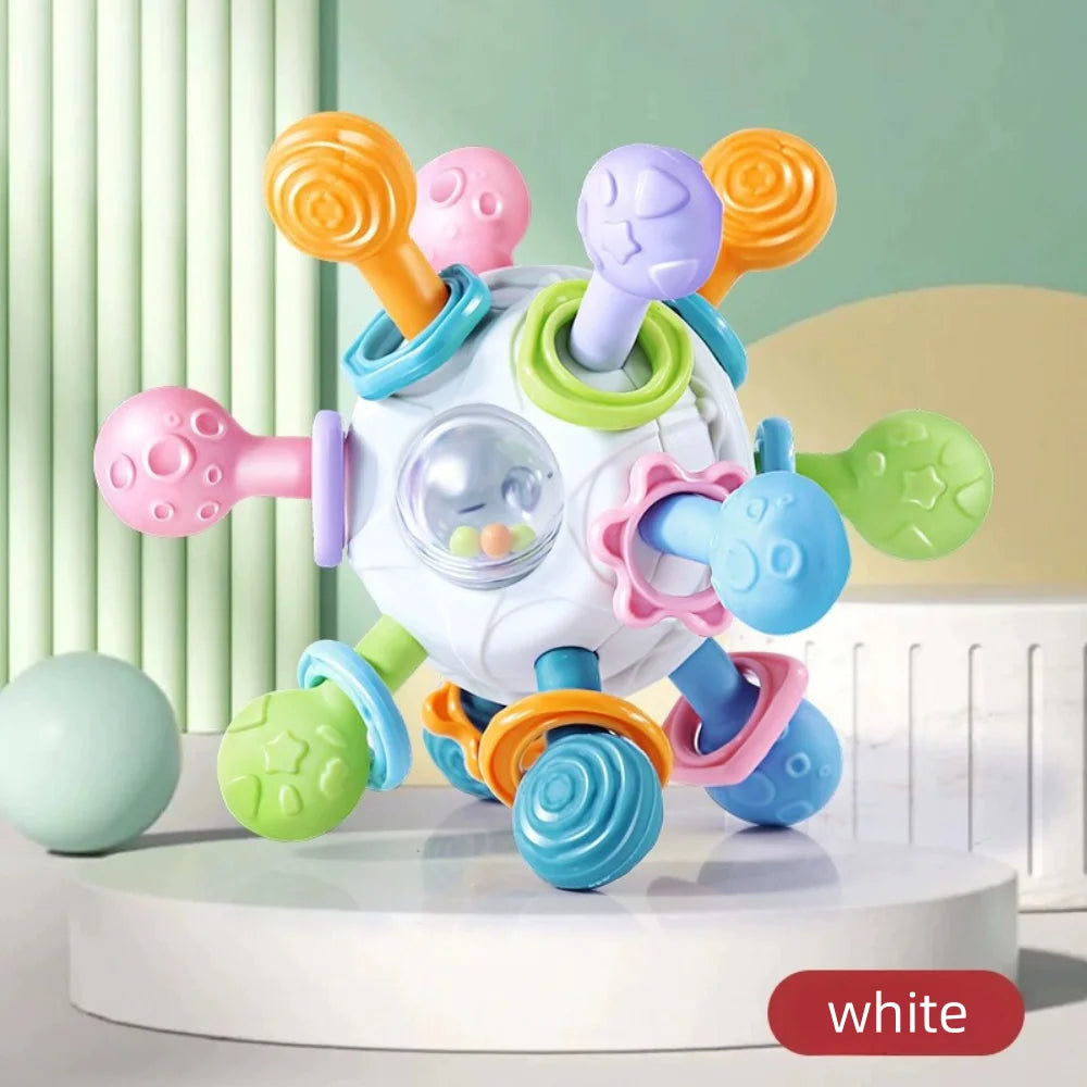 White knobbed ball with colorful knobs on a white podium labeled white