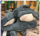 Stack of plush shark toys in a store setting