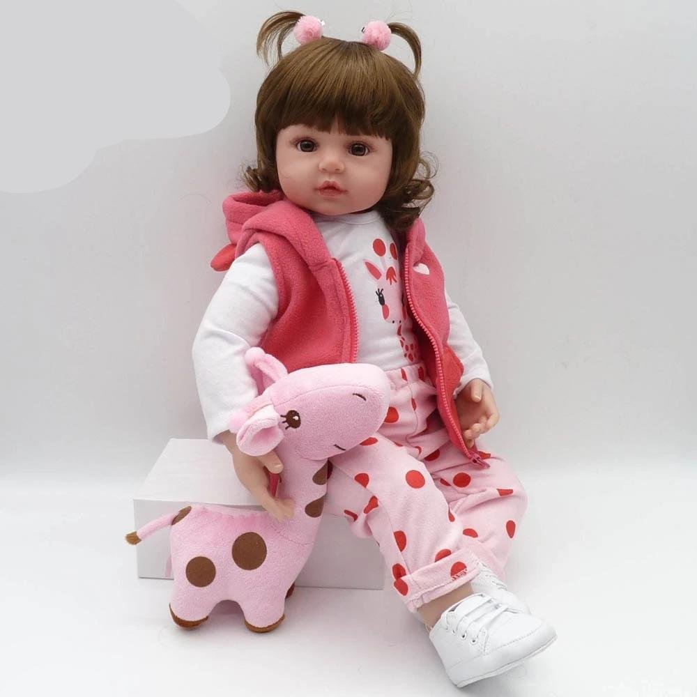 Child's doll wearing a pink outfit with a matching plush toy.