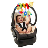 Baby in a car seat with colorful toys hanging above