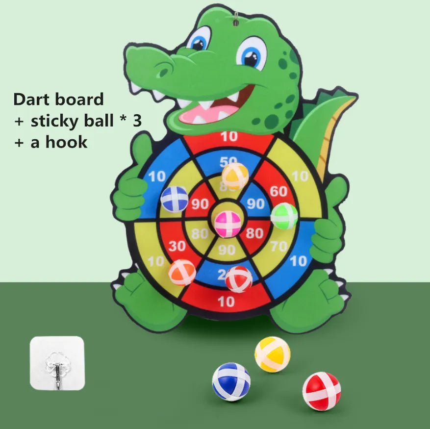 A dartboard shaped like a green dinosaur with three sticky balls.