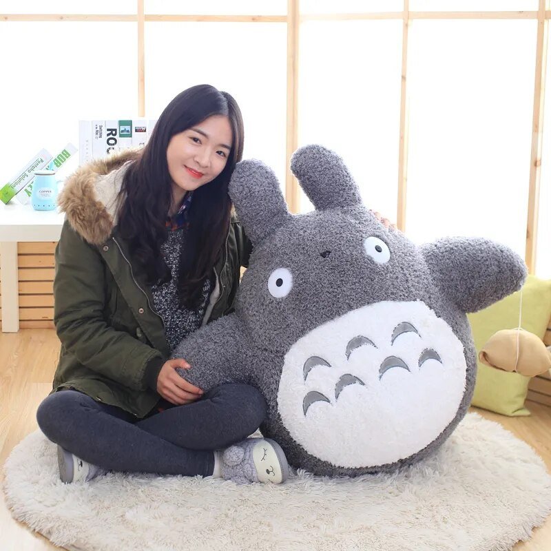 Soft Totoro cartoon cat plush pillow toy held for cuddling and everyday comfort.