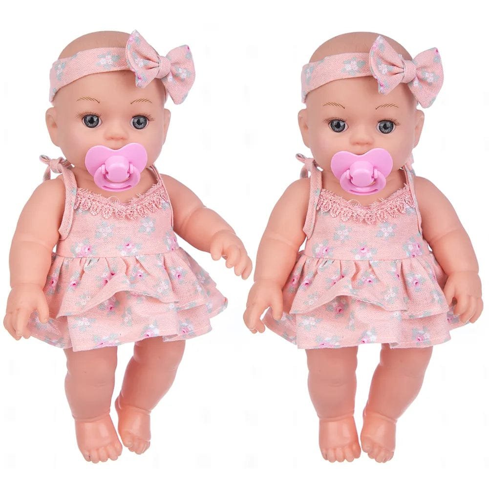 Soft Touch Reborn Baby Doll in matching pink dress and headband, styled as a twin set for nursery play and gifting.