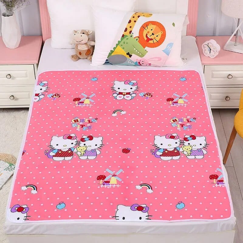 Pink cartoon-themed bedspread on a bed with colorful pillows.