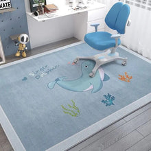 Children's room with a blue dolphin rug and a blue chair.