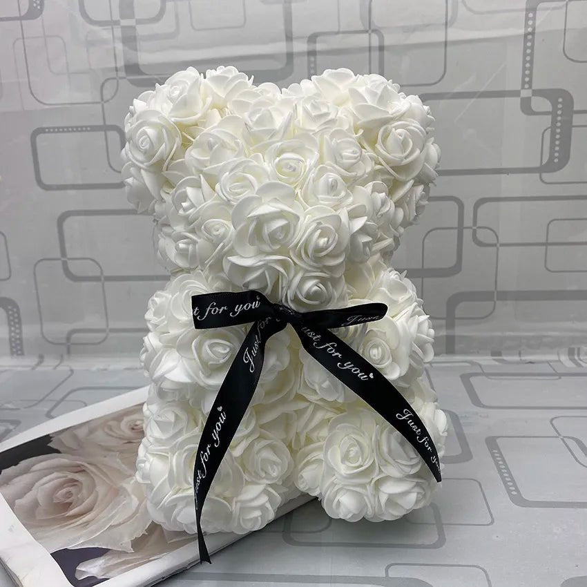 White rose teddy bear with a black ribbon.