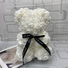 White rose teddy bear with a black ribbon.