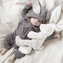 Spring Autumn Newborn Baby Clothes bunny ear romper worn by a baby with a plush toy for cosy daily wear and nursery photos.