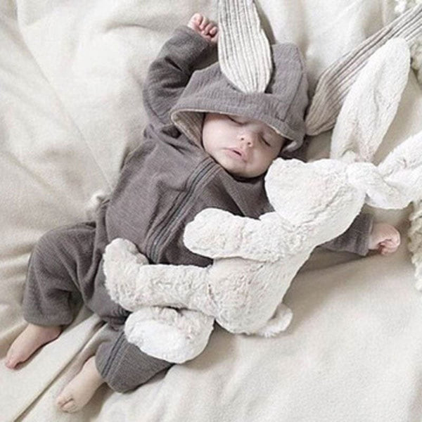 Spring Autumn Newborn Baby Clothes bunny ear romper worn by a baby with a plush toy for cosy daily wear and nursery photos.