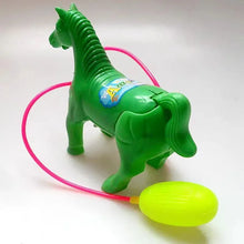 Green plastic horse toy with a pink tube leading to a yellow bulb on a light surface