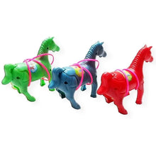 Green, blue-grey and red plastic horse toys with pink tubes wrapped around them on a white background