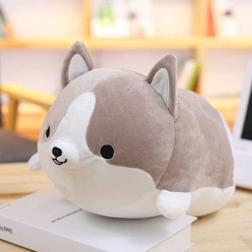 Squishy Corgi Plush Pillow dog-shaped cushion on a book for wrist support, napping, and soft decorative use at home.