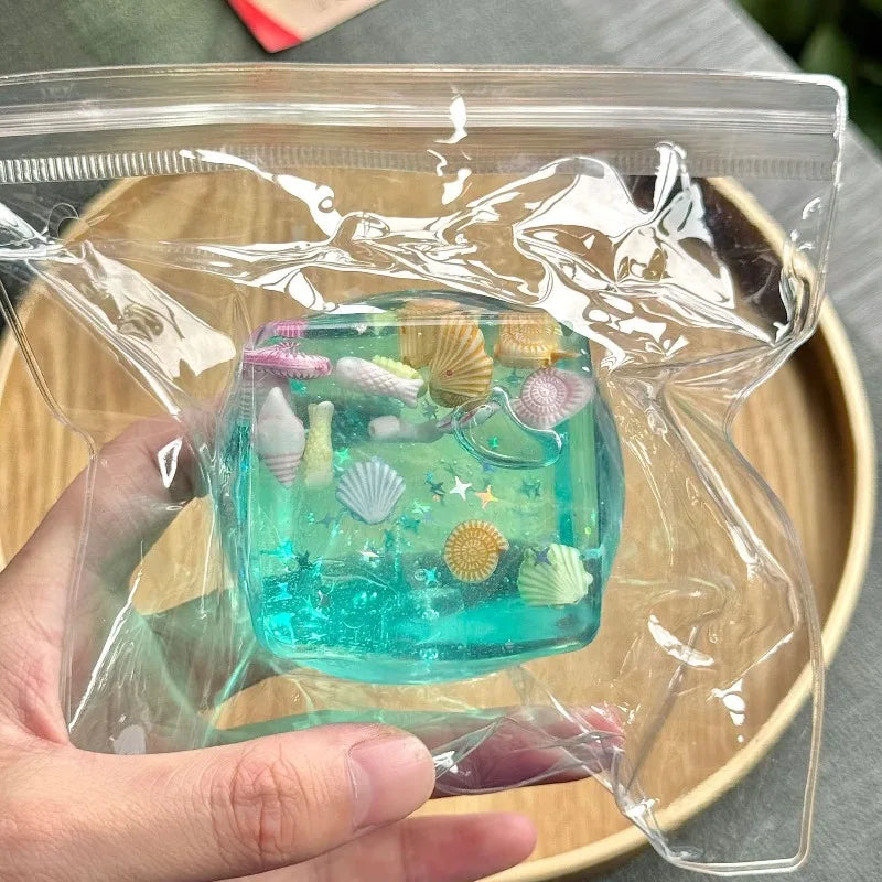 Small decorative container with sea-themed figurines in clear plastic packaging.