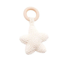 Star crochet baby rattle and teether wooden ring in soft yarn, a light toy for babies to shake and mouth safely.