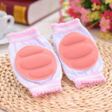 Pair of pink and white knee pads on a woven surface.