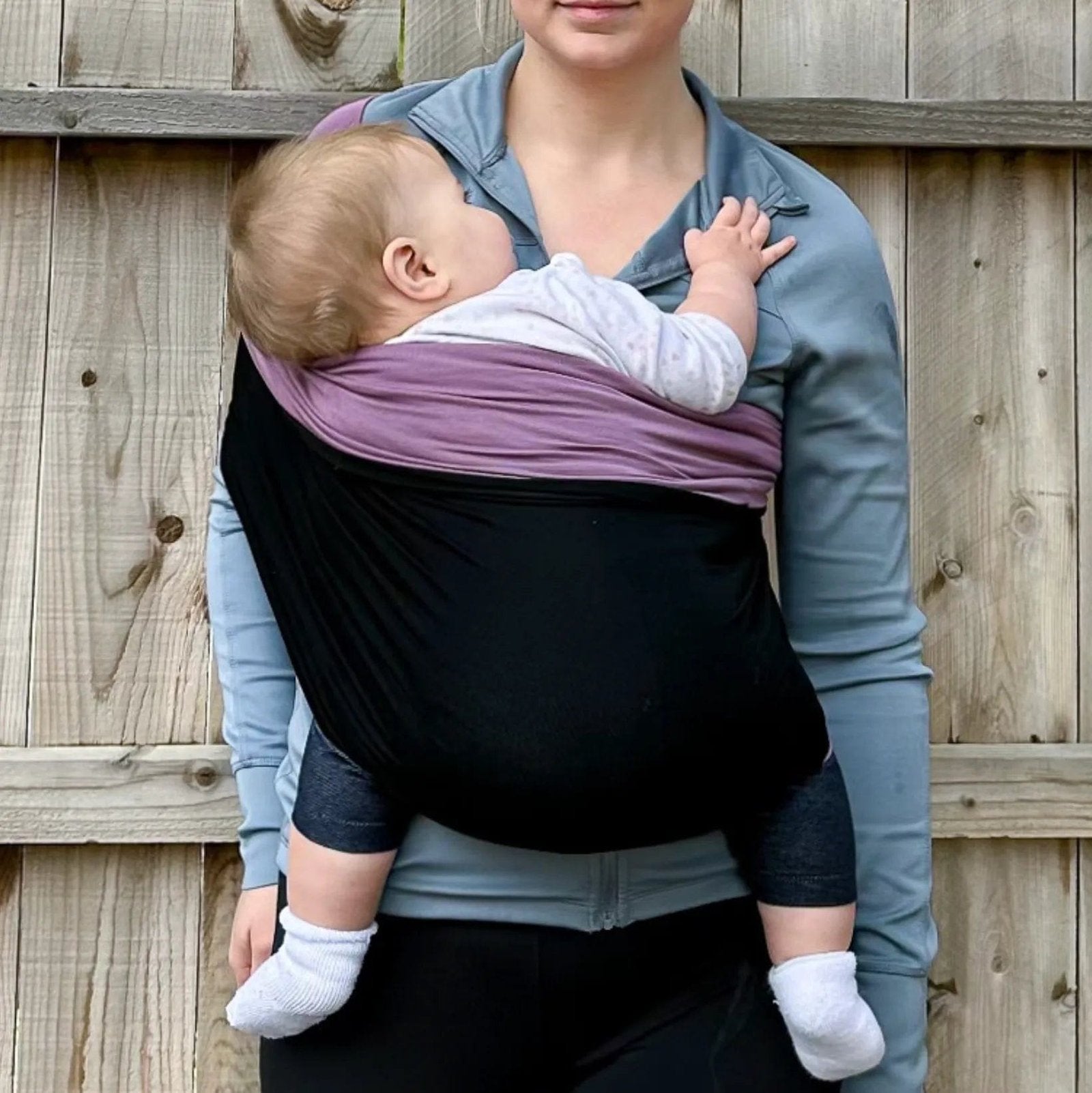 Stretchy Baby Carrier Sling in black and purple worn front-facing for hands-free babywearing, soothing, and daily errands.