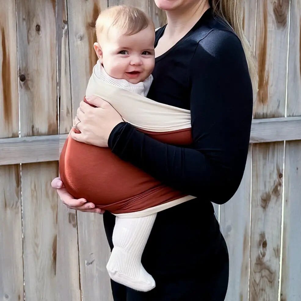 Stretchy Baby Carrier Sling wrap worn outdoors for walks, park trips, and keeping newborns close on the move.