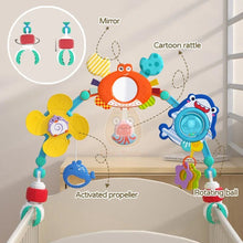 Colorful baby crib mobile with various toys attached to a crib