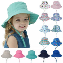 Summer Baby Sun Cap teal floral bucket hat worn by a child for UV protection during beach days and park outings.