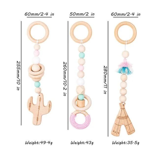 Three wooden baby teething toys with size guide for rotating sensory play on the activity gym.
